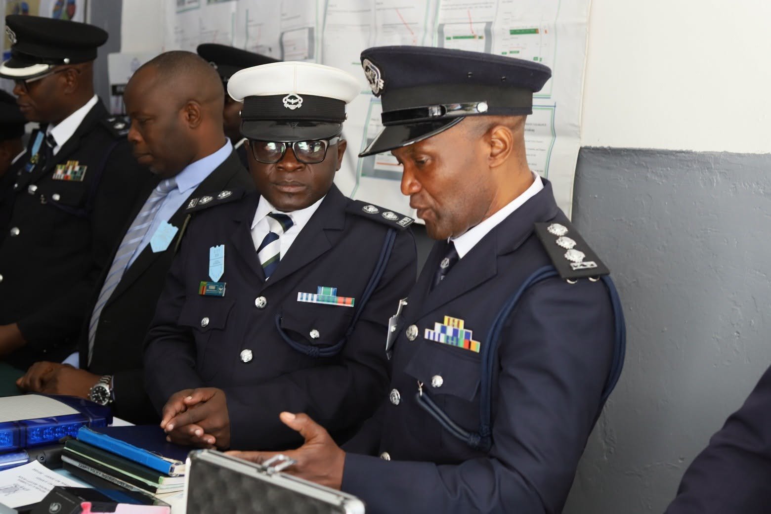 Senior officers reviewing documents at an official briefing